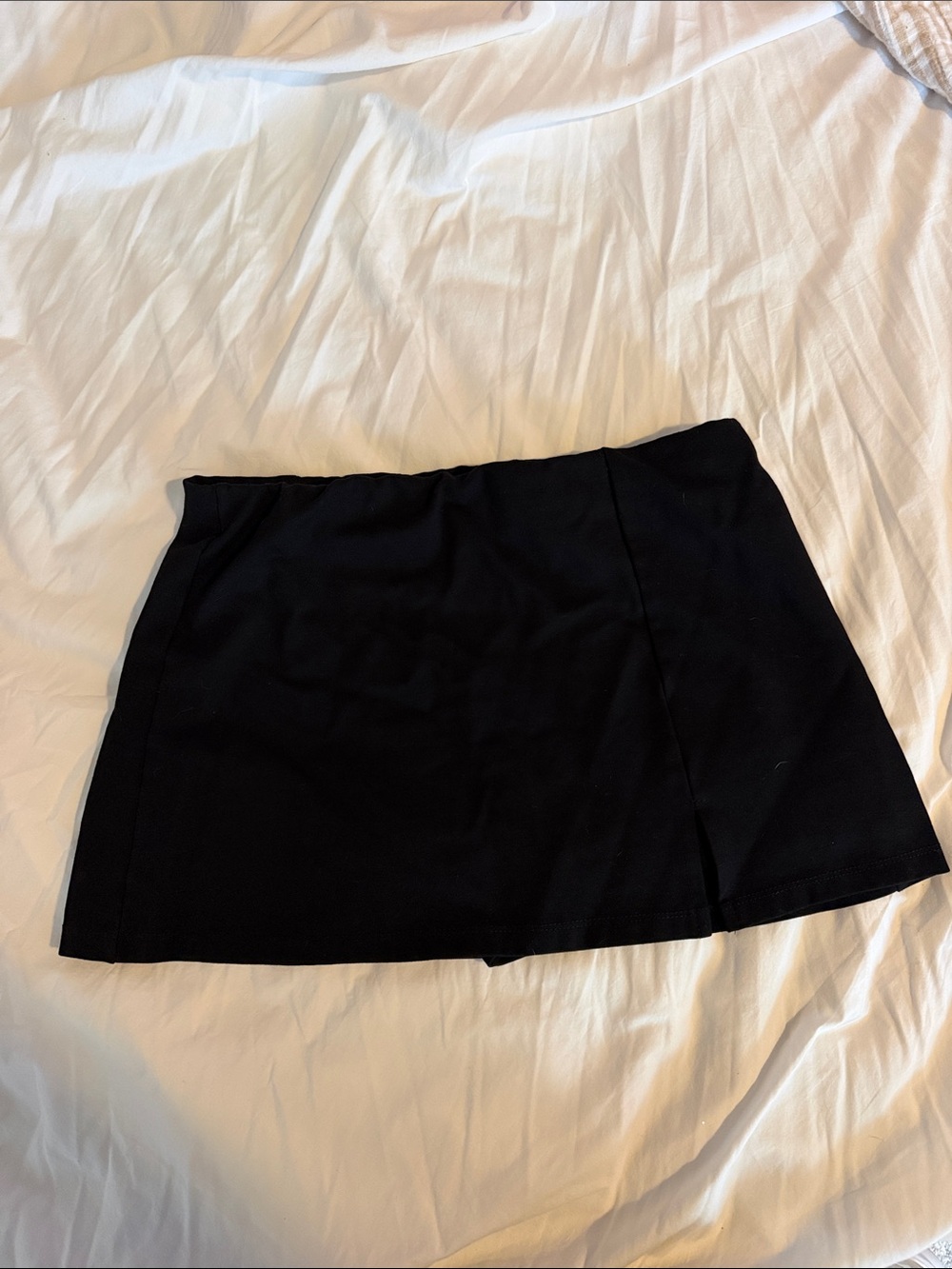 Black mini skirt with small slit